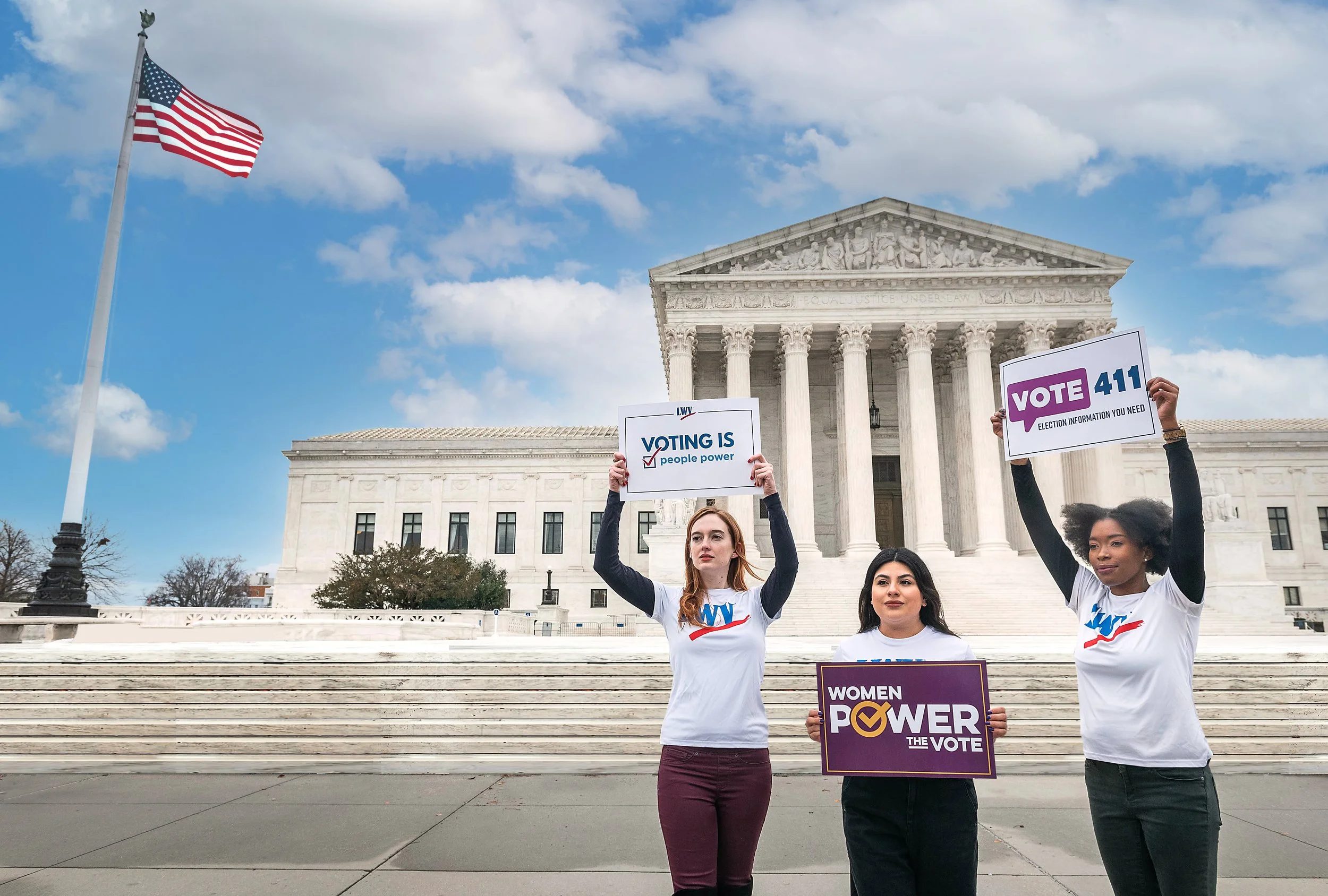 Three people stand in front of the U.S. Supreme Court holding signs promoting voting and voter information, with an American flag visible on the left.