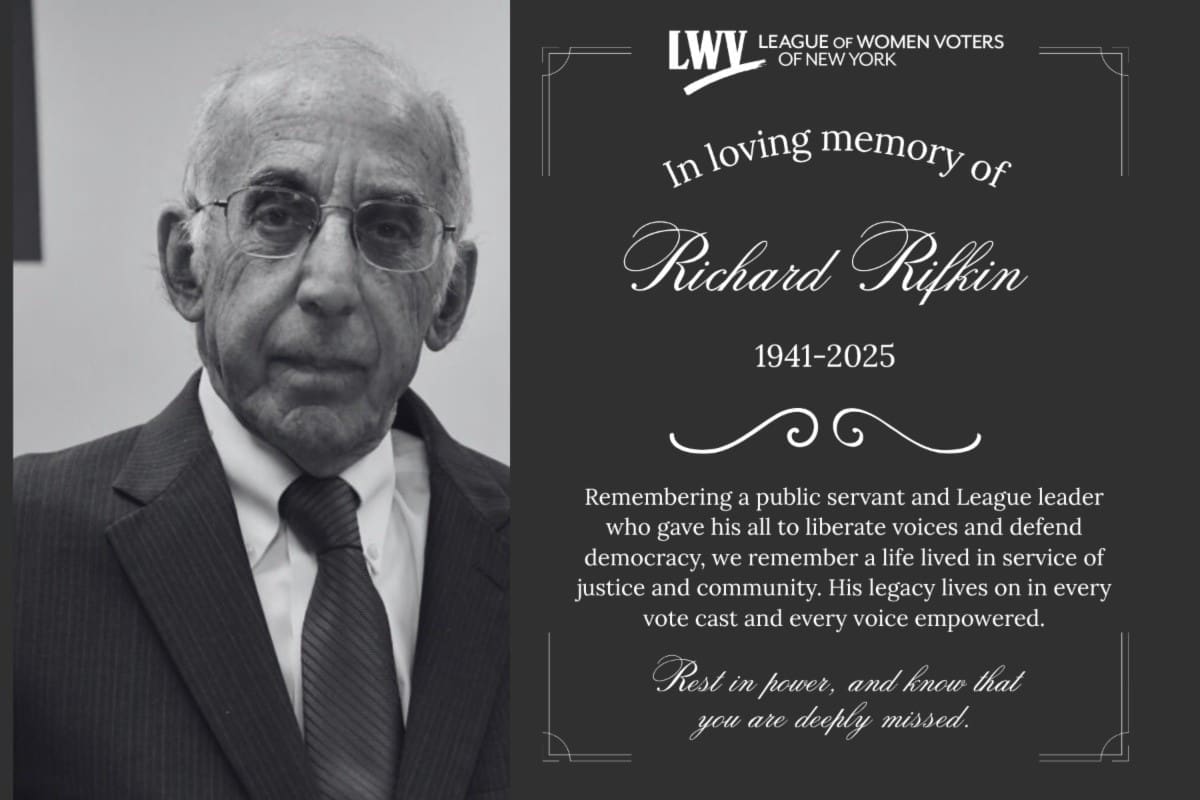 Elderly man in a suit next to a memorial card reading, "In loving memory of Richard Rifkin 1941-2025," with a tribute from the League of Women Voters of New York.